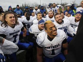 Montreal Carabines' head coach Danny Maciocia talks with the players during the celebration of their 25-10 win over the Guelph Gryphons in the CIS Mitchell Bowl football championship game in Guelph, Ont., on Saturday, November 21, 2015. THE CANADIAN PRESS/Dave Chidley