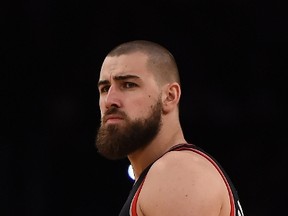 Jonas Valanciunas of the Toronto Raptors looks on  before the start of the game against the Los Angeles Lakers, November 20, 2015 at Staples Center in Los Angeles, California. Valanciunas suffers fractured left hand during the game, which the Raptors won 102-91. (AFP/ROBYN BECK)
