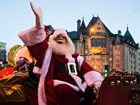 Santa Claus waves to the crowd during the Parade of Lights along Jasper Avenue in Edmonton, Alta., on Saturday, Nov. 21, 2015. Codie McLachlan/Edmonton Sun/Postmedia Network