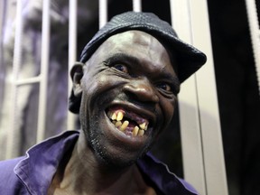 Mison Sere smiles after winning the 2015 edition of the 'Mister Ugly' competition, in Harare, on Nov. 21, 2015. (AP Photo/Tsvangirayi Mukwazhi)