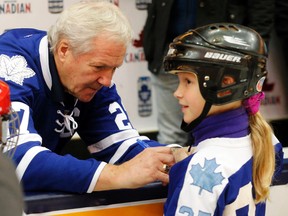 Toronto Maple Leafs legend Darryl Sittler signs the sweater of Georgia at the annual Sun Life Financial Skate with the Leafs in support of Diabetes Awareness Month at the Air Canada Centre on Sunday November 22, 2015. (Michael Peake/Toronto Sun)