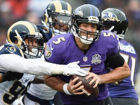 Baltimore Ravens quarterback Joe Flacco (5) is sacked by St. Louis Rams defensive tackle Aaron Donald (99) during the first half of an NFL football game in Baltimore, Sunday, Nov. 22, 2015. (AP Photo/Gail Burton)