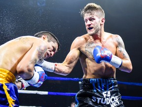 Kingston boxer Tyler Asselstine, right, delivers a punch to Diego Sananco during a super-featherweight bout at the Mississauga Hershey Centre on Saturday night. Asselstine won a unanimous decision. (Supplied photo)