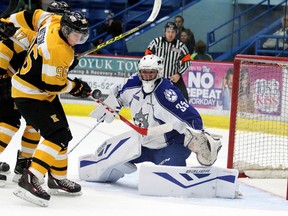 Kingston Frontenacs’ Spencer Watson tries to redirect a loose puck past Wolves goalie Zack Bowman during first-period Ontario Hockey League action at the Sudbury Community Arena on Sunday afternoon. (Gino Donato/Postmedia Network)