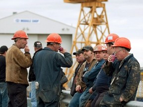 Shipbuilding workers wait to hear the announcement of the awarding of the $25 billion federal shipbuilding contract at the Irving Shipyard in Halifax, Nova Scotia, in this October 19, 2011 file photo.  Irving Shipyard won the contract. (REUTERS/Sandor Fizli)