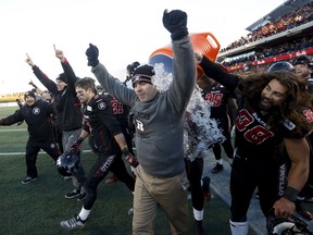 Ottawa Redblacks' head coach Rick Campbell has water poured on him during the final seconds of the CFL eastern final football game against the Hamilton Tiger-Cats in Ottawa, Canada November 22, 2015. REUTERS/Chris Wattie
