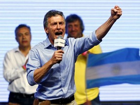 Mauricio Macri, presidential candidate of the Cambiemos (Let's Change) coalition, gestures to his supporters after the presidential election in Buenos Aires, Argentina, November 22, 2015. Conservative opposition candidate Macri comfortably won Argentina's presidential election on Sunday after promising business-friendly reforms to spur investment in the struggling economy. (REUTERS/Ivan Alvarado)