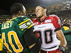 Edmonton's Deon Lacey chats with Calgary's Eric Rogers after winning during the Canadian Football League Western Final between the Edmonton Eskimos and the Calgary Stampeders at Commonwealth Stadium in Edmonton, Alta., on Sunday, Nov. 22, 2015. Codie McLachlan/Edmonton Sun/Postmedia Network