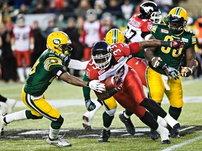 Edmonton's Marcell Young tackles Calgary's Jerome Messam during the Canadian Football League Western Final between the Edmonton Eskimos and the Calgary Stampeders at Commonwealth Stadium in Edmonton, Alta., on Sunday, Nov. 22, 2015. The Eskimos won 45-31. Codie McLachlan/Edmonton Sun/Postmedia Network
