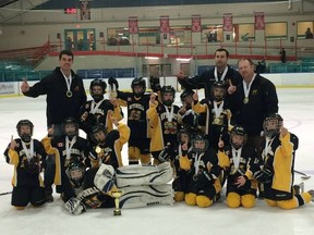 Members of the Mitchell Atoms celebrate their Simcoe tournament championship Sunday, defeating Wallaceburg 5-1 in the final. SUBMITTED PHOTO