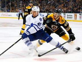 Toronto Maple Leafs' Michael Grabner tries to turn away from Boston Bruins defencman Colin Miller (48) during the third period of the Boston Bruins 2-0 win in an NHL hockey game in Boston, Saturday, Nov. 21, 2015. (AP Photo/Winslow Townson)