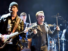 In this Sept. 4, 2015,  file photo, Bono, right, leader of Irish rock band U2, performs in Turin, Italy. (Alessandro Di Marco/ANSA via AP, File)