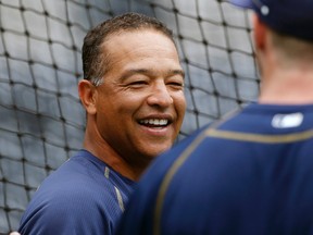 In this June 27, 2015, file photo, San Diego Padres coach Dave Roberts is shown prior to a baseball game against the Arizona Diamondbacks, in San Diego. The Dodgers have made it official, hiring Dave Roberts to be the first minority manager in franchise history. The team announced his hiring Monday, Nov. 23, 2015,  and plans to introduce him on Dec. 1. (AP Photo/Lenny Ignelzi, File)