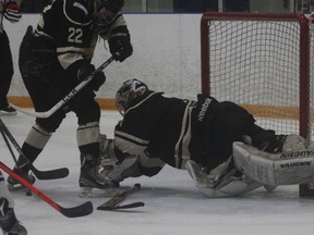 Goderich goalie Nathan Watson dives on top of the puck in a game last year. The Flyers head into playoffs in last place with only two wins. (Laura Broadley/Postmedia Network)