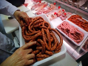 A butcher arranges pieces of sausage at his shop in Marseille, France, October 27, 2015. Eating processed meats like hot dogs, sausages and bacon can cause colorectal cancer in humans, and red meat is also a likely cause of the disease, World Health Organization (WHO) experts said. The review by WHO's International Agency for Research on Cancer (IARC), released on Monday, said additionally that there was some link between the consumption of red meat and pancreatic cancer and prostate cancer.  REUTERS/Jean-Paul Pelissier