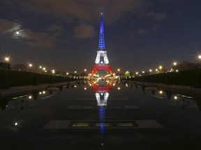 The Eiffel Tower lit with the blue, white and red colours of the French flag is reflected in the Trocadero fountains in Paris, France, November 23, 2015, a week after a series of deadly attacks in the French capital.   REUTERS/Christian Hartmann