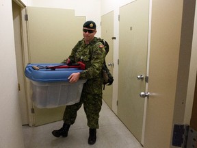 Lars Hagberg/THE CANADIAN PRESS
Sgt. Matt MacIsaac removes some of his belongings from storage at CFB Kingston in Kingston, Ont., on Monday Nov. 23, 2015. Several barracks on the base may be used to house Syrian refugees.