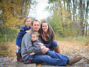Susan Sabramsky Nichol/MAE Photography
Will (B.J.) Ketcheson holds his son, Ryder, 2, in a family portrait with his wife, Suzanna, and daughter, Ellie, 4, in Napanee Thursday, Nov. 12, 2015. He has stage-four lung cancer but says an online fundraising campaign and help from family and friends are helping his family during his treatment.