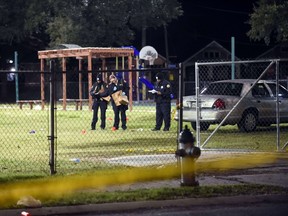 Police gather evidence after a shooting at a playground on November 22, 2015 in New Orleans, Louisiana. According to reports, as many as 16 people were shot at Bunny Friend Park while attending a party at a playground.  Cheryl Gerber/Getty Images/AFP