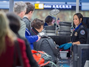 This December 23, 2014 file photo shows airline travellers as they are processed at a Transportation Safety Agency (TSA) security checkpoint at Dulles International Airport in Virginia. The U.S. State Department has issued a worldwide travel alert because of what it described as "increased terrorist threats." AFP PHOTO / PAUL J. RICHARDS