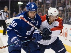 Roman Polak (left) of the Toronto Maple Leafs battles Jonathan Huberdeau of the Florida Panthers during NHL action at the Air Canada Centre on Tuesday February 17, 2015. (Craig Robertson/Toronto Sun/Postmedia Network)