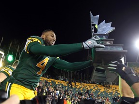 Adarius Bowman didn't hesitate to grab the West Division championship trophy after Sunday's game at Commonwealth Stadium. (Perry Mah, Edmonton Sun)