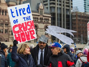 Kamilla Petrick (left) with TTCriders demonstrate against inadequate service and rising fares at City Hall on Monday. (ERNEST DOROSZUK, Toronto Sun)