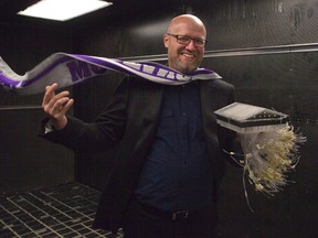 Western University researcher Greg Kopp holds a model house used in wind tunnel tests in London. Kopp wants the building code revised to require hurricane clips, which he says would help keep the roof on a house during wild weather. (DEREK RUTTAN, The London Free Press)