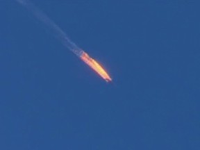 This frame grab from video by Haberturk TV, shows a Russian warplane on fire before crashing on a hill as seen from Hatay province, Turkey, Tuesday, Nov. 24, 2015. Turkey shot down the Russian warplane Tuesday, claiming it had violated Turkish airspace and ignored repeated warnings. Russia denied that the plane crossed the Syrian border into Turkish skies. (Haberturk TV via AP)
