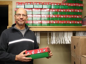 Pastor Robert Cox stands beside many filled Shoeboxes for Operation Christmas Child. Local residents, churches and citizens from as far away as Moosonee are sending children across the world some joy this season.