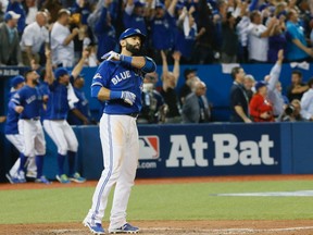 Jose Bautista of the Toronto Blue Jays hits a three-run homer in the 7th Inning against the Texas Rangers in game five of the American League Division Series in Toronto, Ont. on Wednesday October 14, 2015. (STAN BEHAL /Toronto Sun/Postmedia Network)