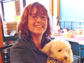 Founder of Adopt-a-Pet PetRescue Lucknow, Kathi Newell-Nicholson holds her own dog Buddy, who was also a rescue. Buddy is a former puppy mill dog. He was one of over 70 dogs that were rescued when the mill was closed. She held a fundraising sale in Lucknow on Oct. 31, 2015. (Valerie Gillies/Lucknow Sentinel)