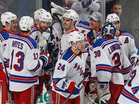 New York Rangers forward Rick Nash (61) is mobbed by teammates after scoring his third goal of the game and game winner during the overtime period of an NHL hockey game against the Florida Panthers, Saturday, Nov. 21, 2015, in Sunrise, Fla. The Rangers won 5-4. (AP Photo/Joel Auerbach)