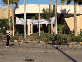 A man looks at the damage outside the Swiss Inn hotel in the Egyptian town of El-Arish, in the Sinai peninsula, following an attack on the hotel by two suicide bombers and a gunman on Nov. 24, 2015. (AFP PHOTO/STR)