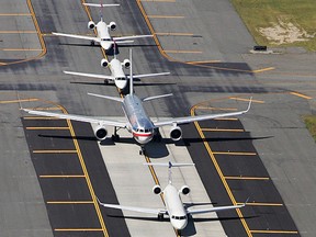 In this Sept. 8, 2008, file photo, planes are lined up on a runway at John F. Kennedy International Airport, in New York. (AP Photo/Mark Lennihan, File)
