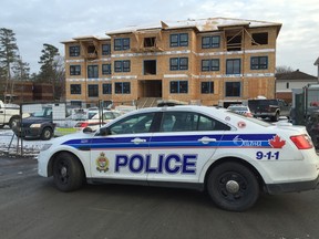 Police block the entrance to a construction site at Innes and Bearbrook roads after a worker was critically injured in a fall from the roof Tuesday. (ERROL McGIHON Ottawa Sun)