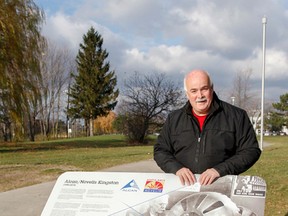 Rolland Billings, chair of the Kingston Alcan/Novelis plants 75th anniversary committee, stands behind the new historic plaque installed at Princess and Concession streets earlier in November, in honour of Alcan/Novelis Kingston Works in Kingston, Ont. on Tuesday November 24, 2015. Julia McKay/The Kingston Whig-Standard/Postmedia Network