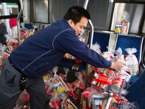 ETS Operator Johnny Ho load donations on to a bus during the 2015 ETS Stuff a Bus campaign kick-off at the Mayfield Save-On Foods location, 360 Mayfield Common, in Edmonton, Alta. on Tuesday Nov. 24, 2015. From Nov. 25 to Nov. 27 ETS buses will be at various Save-On Foods locations collecting donations of non-perishable food items for the Edmonton Food Bank. On Saturday Nov. 28 ETS buses will be at all Edmonton Save-On Foods locations collecting donations. This year's goal is to fill fifteen buses. David Bloom/Edmonton Sun