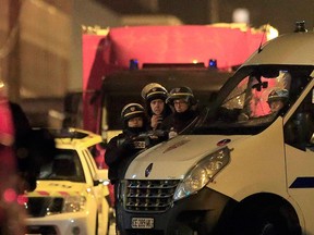 Police take up position near the scene of a shootout in Roubaix, northern France, Nov. 24, 2015.  REUTERS/Pascal Rossignol