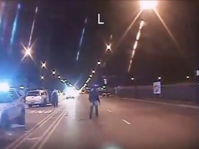 An image from released video of 17-year-old Laquan McDonald as he is approached by Chicago police officers, including officer Jason Van Dyke, on Oct. 20, 2014. Van Dyke was charged on Tuesday with murdering the black teenager. (YouTube/Screengrab)