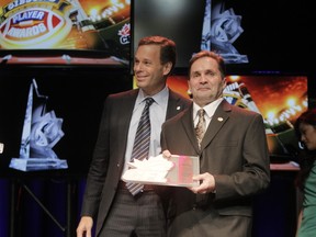 Dwayne Mandrusiak was presented with the Commissioner's Award by then CFL commissioner Mark Cohon at the 2013 Grey Cup in Regina. (Lyle Aspinall, Postmedia Network)