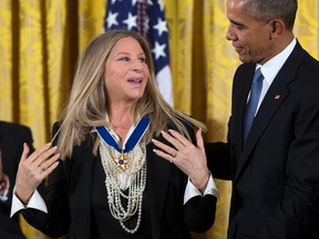 President Barack Obama, right, presents the Presidential Medal of Freedom to Barbra Streisand during a ceremony in the East Room of the White House, on Tuesday, Nov. 24, 2015, in Washington. Obama is recognizing 17 people with the nation’s highest civilian award, including one of the greatest catchers in baseball history and a “Funny Girl.” (AP Photo/Evan Vucci)