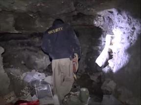 In this image made from video taken on Sunday, Nov. 22, 2015, a member of Kurdish security forces shows a tunnel complex under the city of Sinjar, northern Iraq that were used by Islamic State fighters to move undetected and avoid coalition airstrikes before the town was retaken from the militants. (AP Photo via AP video)