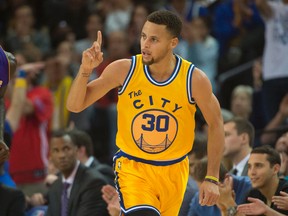 Golden State Warriors guard Stephen Curry (30) celebrates against the Los Angeles Lakers during the first quarter at Oracle Arena. Mandatory Credit: Kyle Terada-USA TODAY Sports