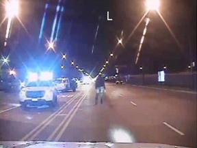 Laquan McDonald, right, walks on a road before he was shot 16 times by police officer Jason Van Dyke in Chicago, in this still image taken from a police vehicle dash camera video shot on October 20, 2014, and released by Chicago Police on November 24, 2015. Van Dyke, a white Chicago policeman was charged on Tuesday with murdering black teenager McDonald, a prosecution that was speeded up in hopes of staving off a fresh burst of the turmoil over race and police use of deadly force that has shaken the U.S. for more than a year. (REUTERS/Chicago Police Department/Handout via Reuters)
