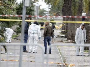 Tunisian forensics police inspect the scene of a suicide bomb attack in Tunis, Tunisia, on Nov. 25, 2015. (REUTERS/Zoubeir Souissi)