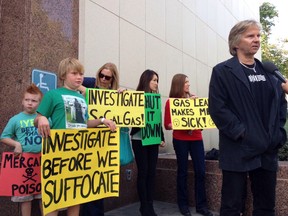 Matt Pakucko, president of Save Porter Ranch, right, speaks to a reporter after testifying to the Los Angeles County Board of Supervisors about an uncontrolled gas leak that has sickened residents in his Los Angeles neighbourhood on Tuesday, Nov. 24, 2015. Other Porter Ranch residents in the background from left to right: Ethan Michaels, 8, Cameron Michaels, 11, Danielle Michaels, the boys' mother, Kyoko Hibino and Michelle Theriault.  SoCalGas crews and technical experts are attempting to safely stop the flow of natural gas leaking from a storage well at the utility’s Aliso Canyon facility near Northridge section of Los Angeles. Workers are trying to stop a  leak from a massive underground natural gas well on the that has nearby residents concerned for their safety and annoyed by the unpleasant smell. (AP Photo/Brian Melley)