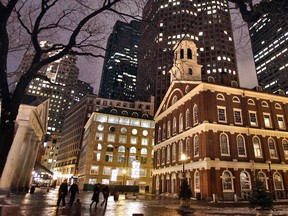 In this Feb. 22, 2007 file photo, Faneuil Hall, right, appears at night in downtown in Boston. Faneuil Hall is one of the historic sites on Boston's Freedom Trail.  (AP Photo/Michael Dwyer, File)