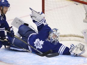 Toronto Maple Leafs goalie James Reimer (34) makes a save against the Vancouver Canucks at the Air Canada Centre. (Tom Szczerbowski/USA TODAY Sports)