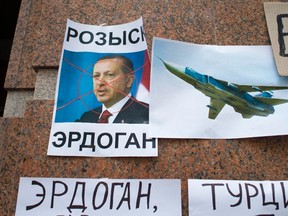 Posters showing a portrait of Turkish President Recep Tayyip Erdogan and reading "Wanted,"  "Erdogan, Turkey," are left after a protest at the Turkish Embassy in Moscow, Russia, Wednesday, Nov. 25, 2015. Protesters have hurled eggs and stones at the Turkish embassy in Moscow a day after Turkey shot down a Russian warplane Tuesday near the Syrian border. (AP Photo/Ivan Sekretarev)